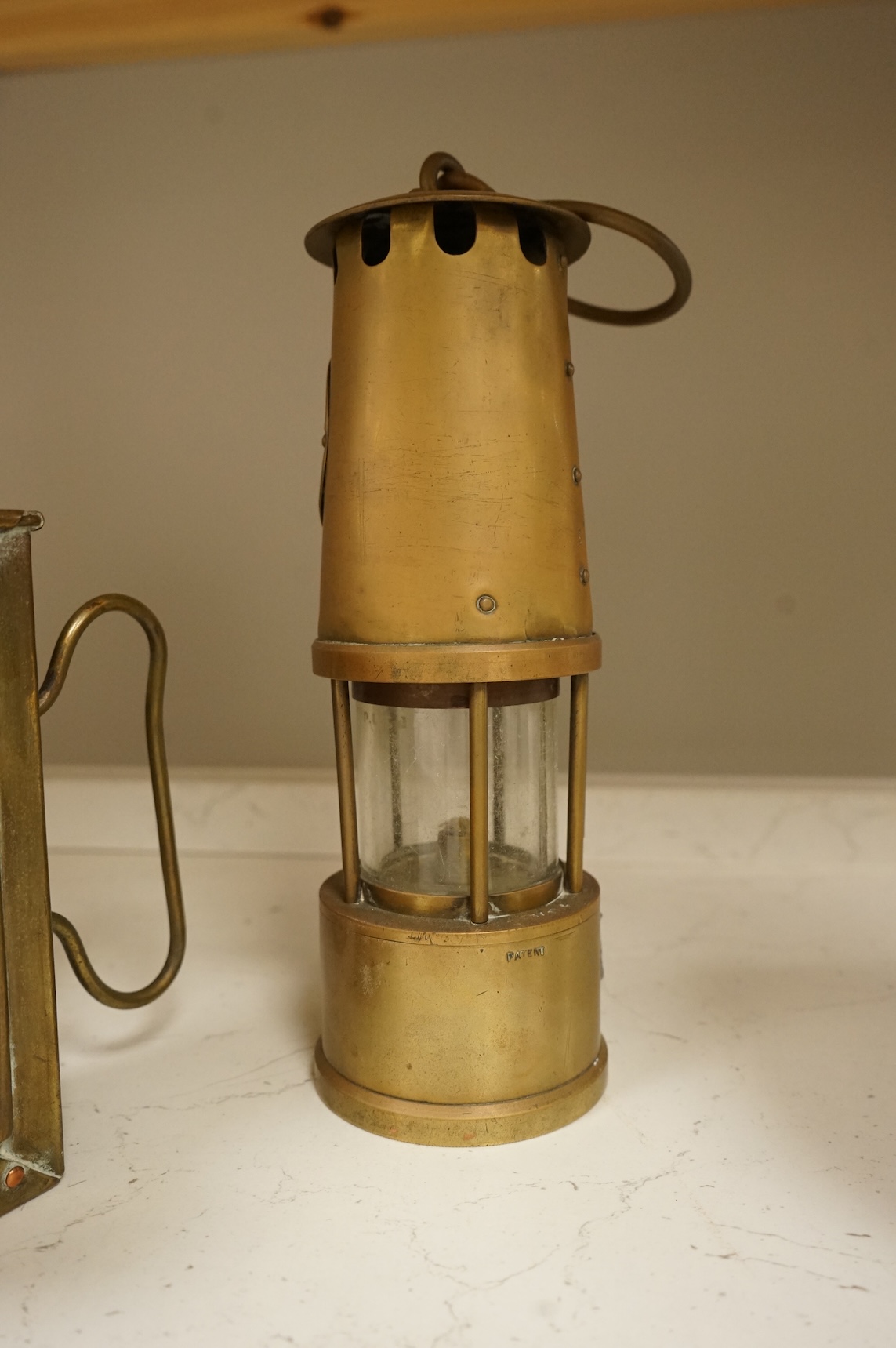 A railway lamp, a vintage Eccles Protector miners lamp and another, largest 17cm high